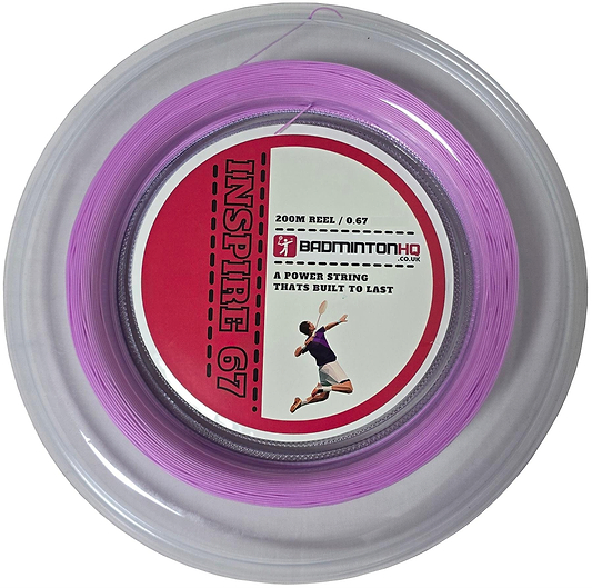 Close-up of a light pink, 0.67mm, 200m badminton string reel labeled "BadmintonHQ Inspire 67 Zoom Badminton String," in a circular plastic case with a red and white label featuring an action shot of a player.