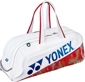 The Yonex 02631WEX Expert Tournament Badminton Bag in white features red accents, red handles, a blue Yonex logo, and a stylish red and gold base—perfect for tournaments.