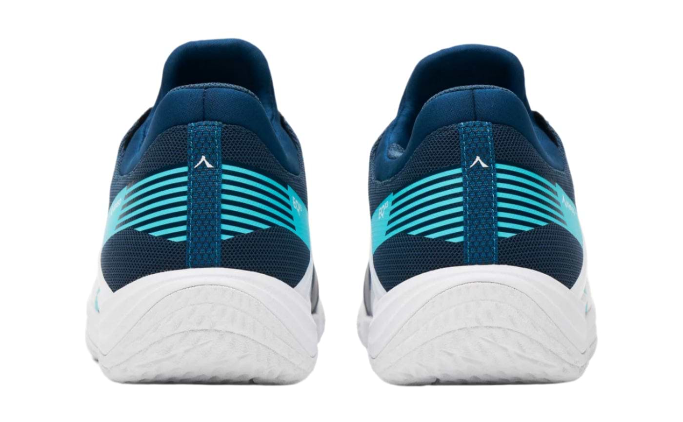 A rear view of Kanso Equilibrium EQx3 badminton shoes in navy with teal and white accents. Their sleek design includes wave patterns and a thick white sole for better energy return, positioned side by side against a plain background.