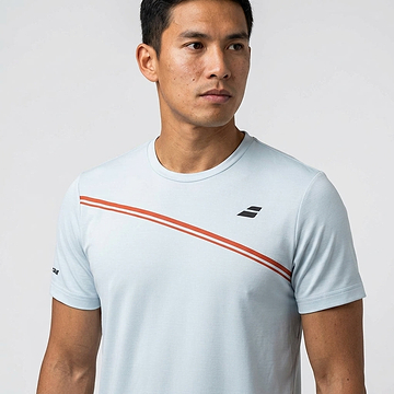 A man in a Babolat Play Men's Crew Neck Badminton T-Shirt in Illusion Blue stands against a plain light background, looking to the side—the ideal pick for fans of Babolat badminton shirts.