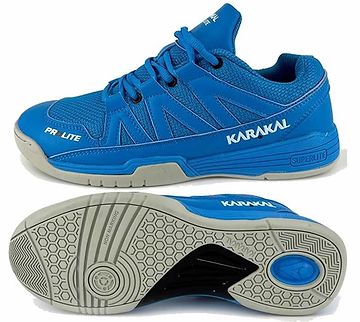 A pair of Karakal KF Pro Lite Badminton Shoes in blue, featuring shock-absorbing gel insoles and gray soles. The upper is made of mesh and synthetic material with "Karakal" written in white. The shoe's sole includes a circular pattern for grip, offering non-marking performance and superior lateral stability.