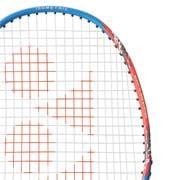 Close-up of a Yonex Nanoflare E13 badminton racket featuring a blue and red frame with white strings. The strings create a pattern with red markings, highlighting its isometric head shape. The racket stands upright against a plain white background.