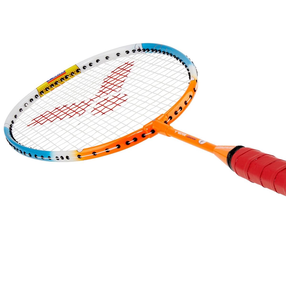 A close-up of the Victor Advanced Junior Badminton Racket - Orange Blue showcases its orange frame with white and blue accents. The durable multifilament red strings form a pattern, and the grip is wrapped in red tape, all set against a white background.