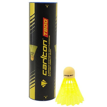 Standing upright is a tube marked "Carlton T800 Yellow Medium Badminton Nylon Shuttles," which accompanies a yellow synthetic shuttlecock featuring a cork tip. The tube features a black and yellow design, ideal for club use, highlighting its durability and exceptional flight quality.