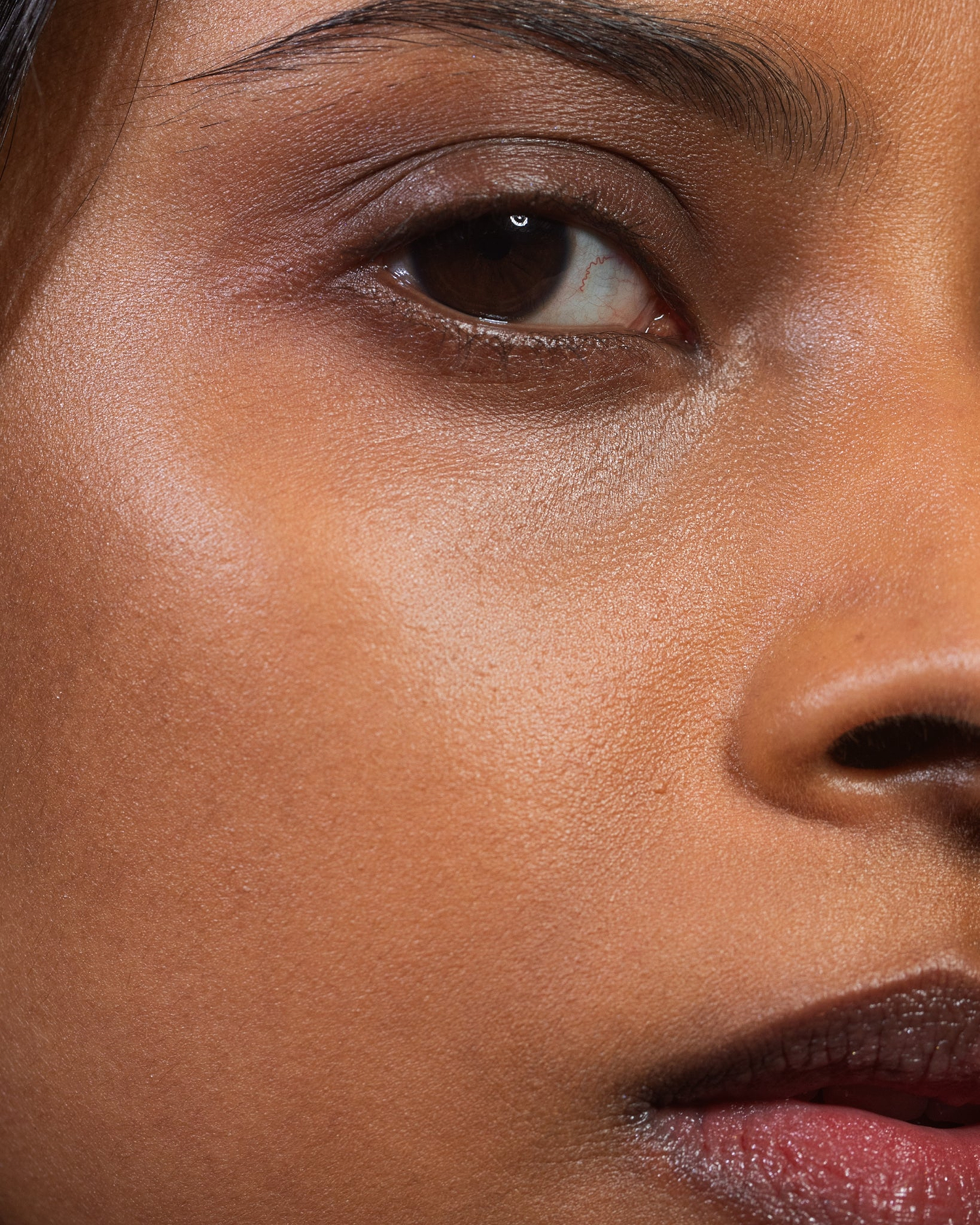 Model wearing MÁDARA Organic Skincare dream flower serum on A3515 serum on skin; close-up portrait shows natural application results.