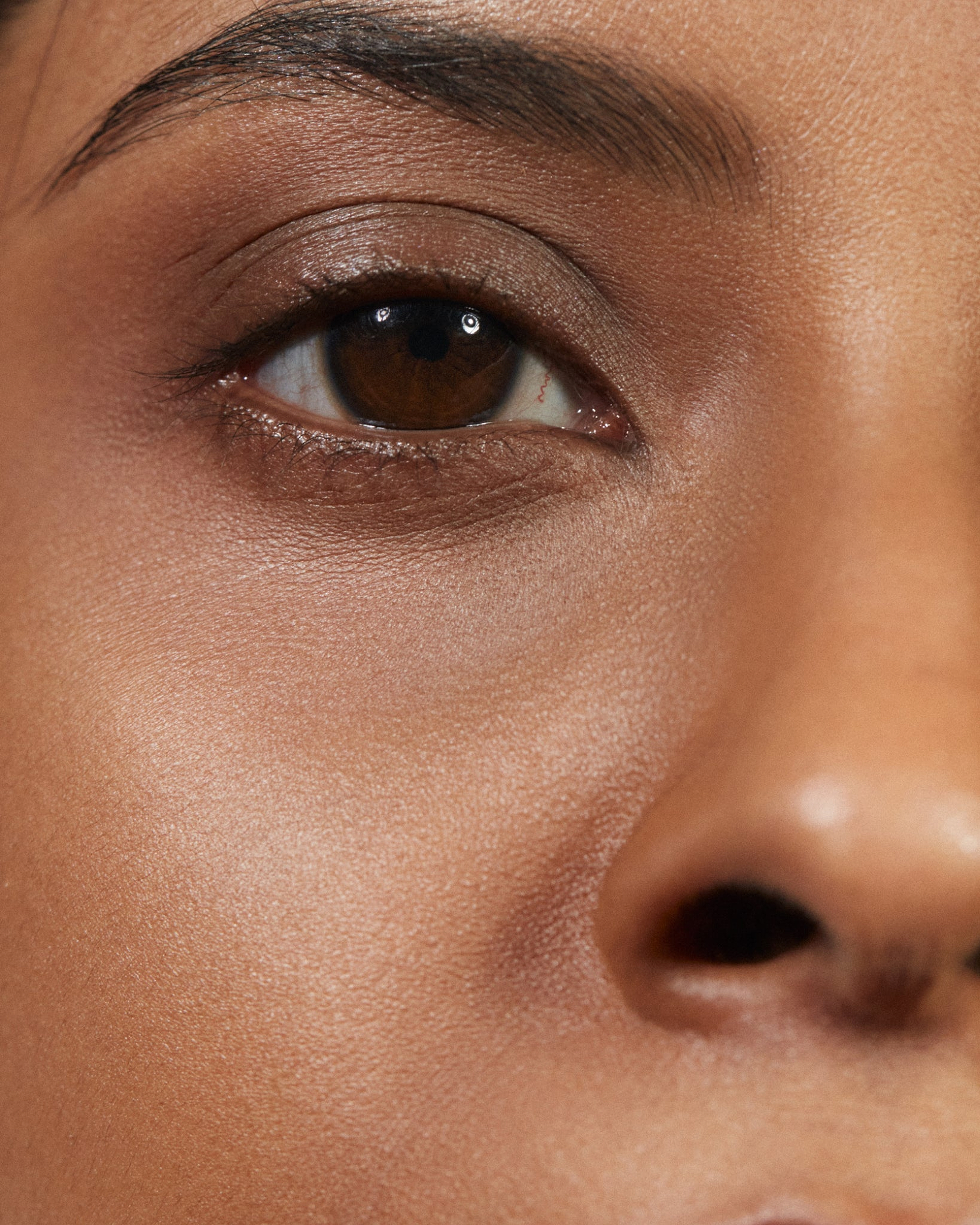 Model wearing MÁDARA Organic Skincare the concealer amber on A6115 concealer on skin; close-up portrait shows natural application results.