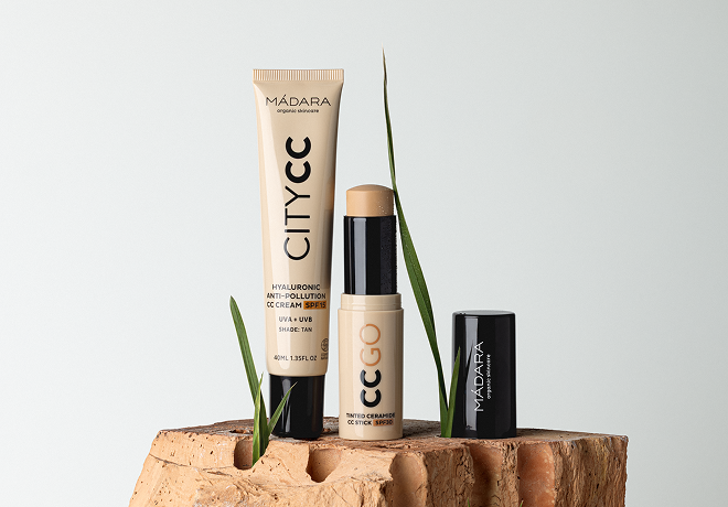 MÁDARA City CC cream and CC Go stick displayed on stacked bricks with green grass blades