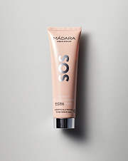 Model wearing MÁDARA Organic Skincare instant moisture radiance face mask A3025 face mask on skin; close-up portrait shows natural application results.