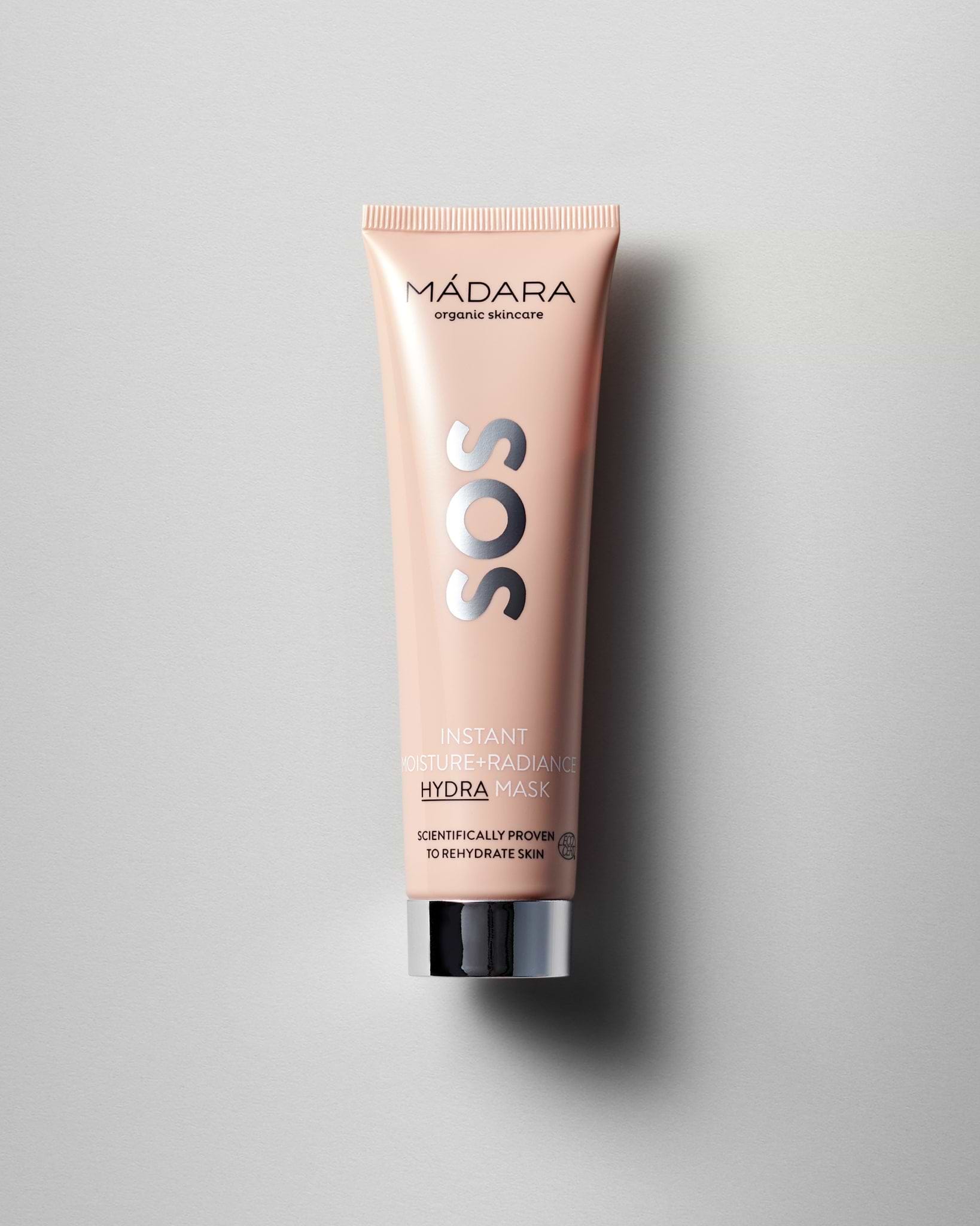 Model wearing MÁDARA Organic Skincare instant moisture radiance face mask A3025 face mask on skin; close-up portrait shows natural application results.