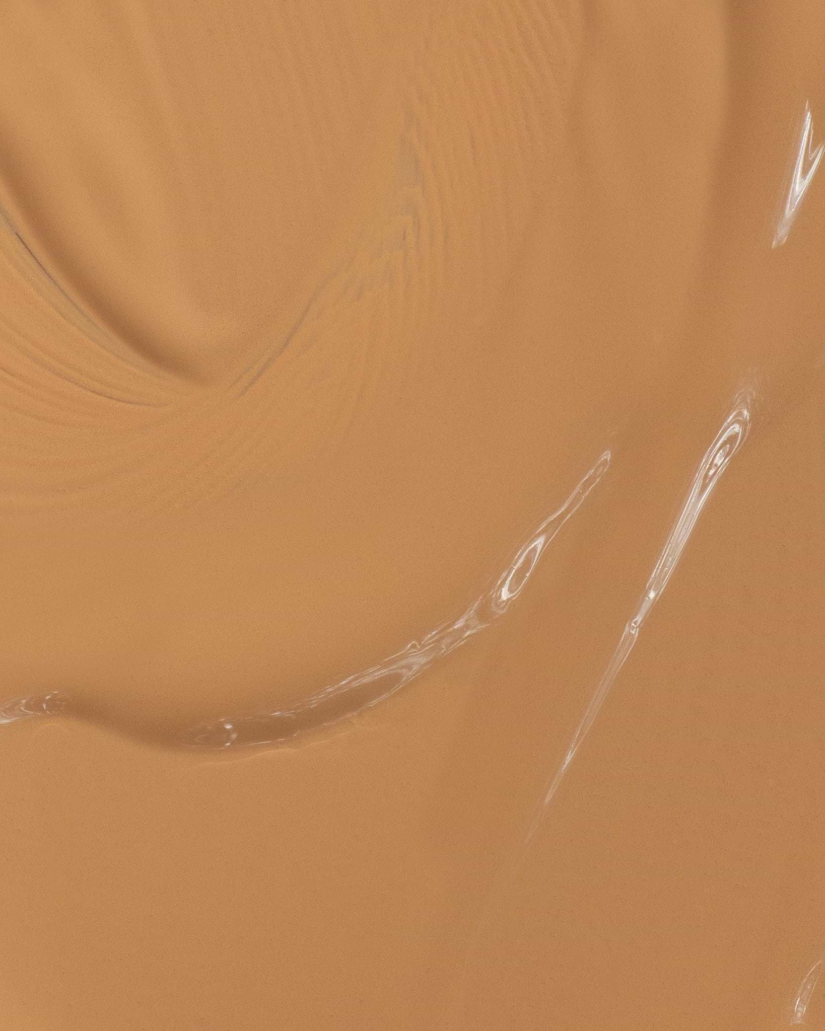 Texture close-up of MÁDARA Organic Skincare skin equal foundation olive A6061 foundation �swatch demonstrates consistency and finish.
