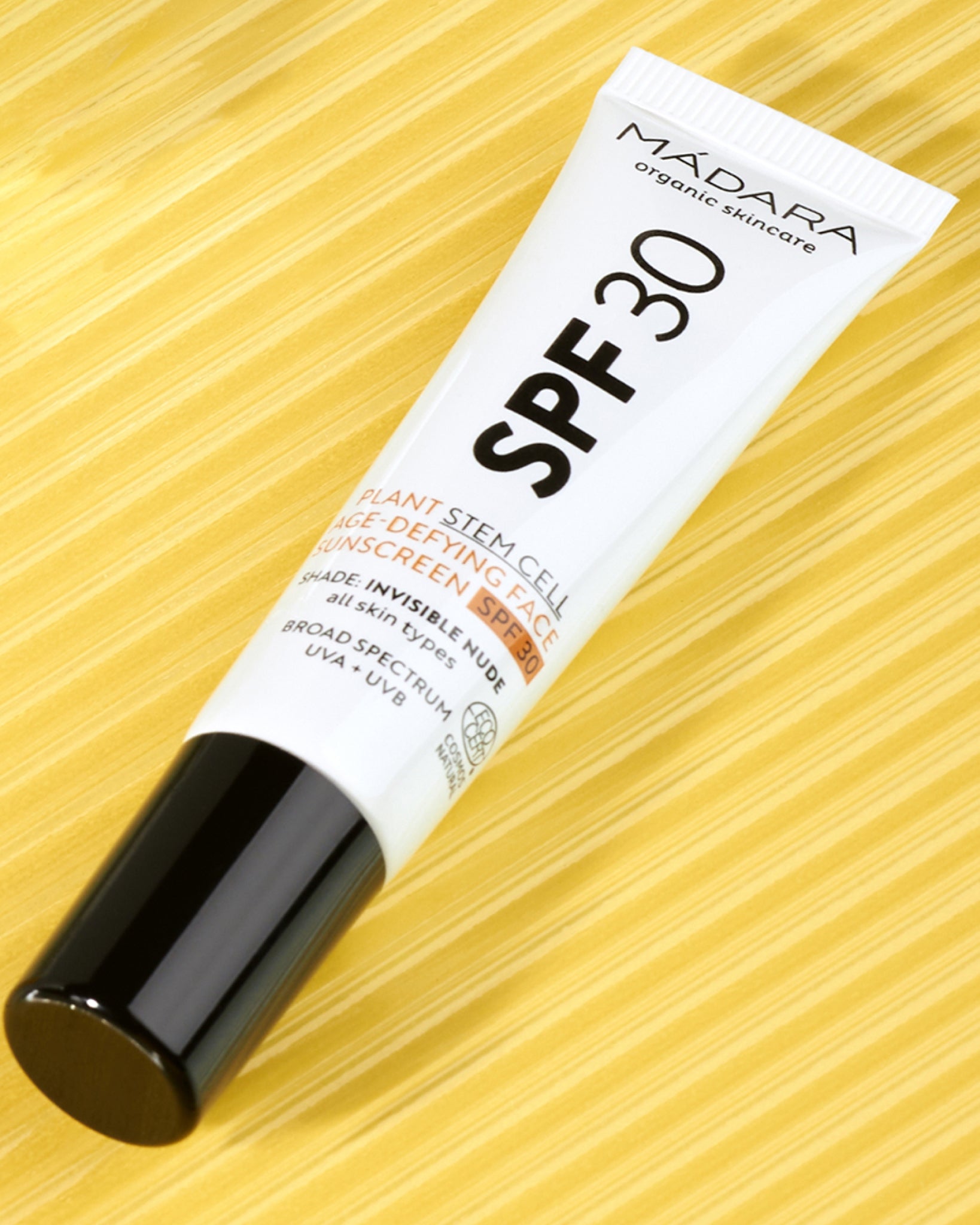 Model wearing MÁDARA Organic Skincare spf30 for face SM3415 10 on skin; close-up portrait shows natural application results.