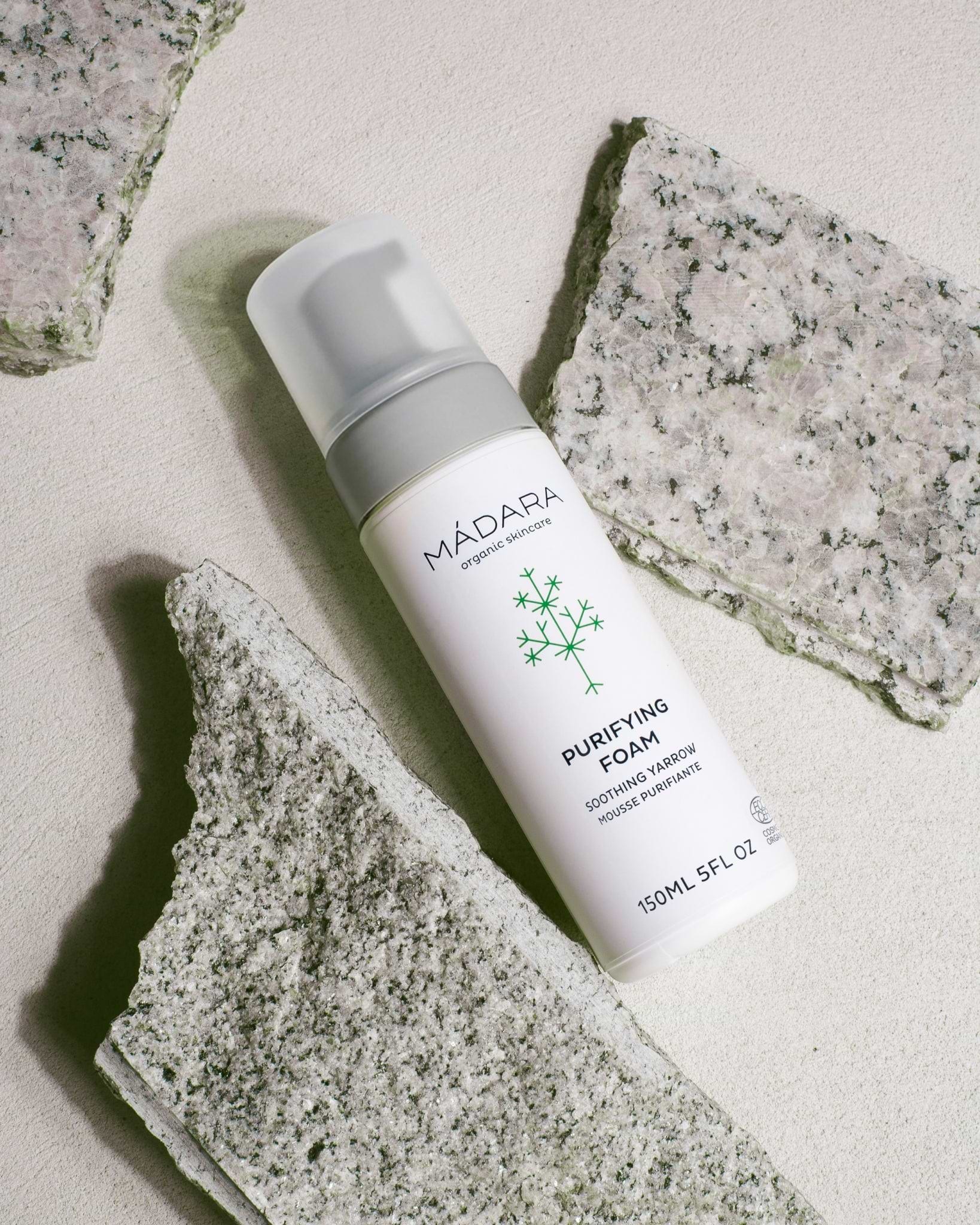 MADARA Purifying Foam bottle on a stone surface