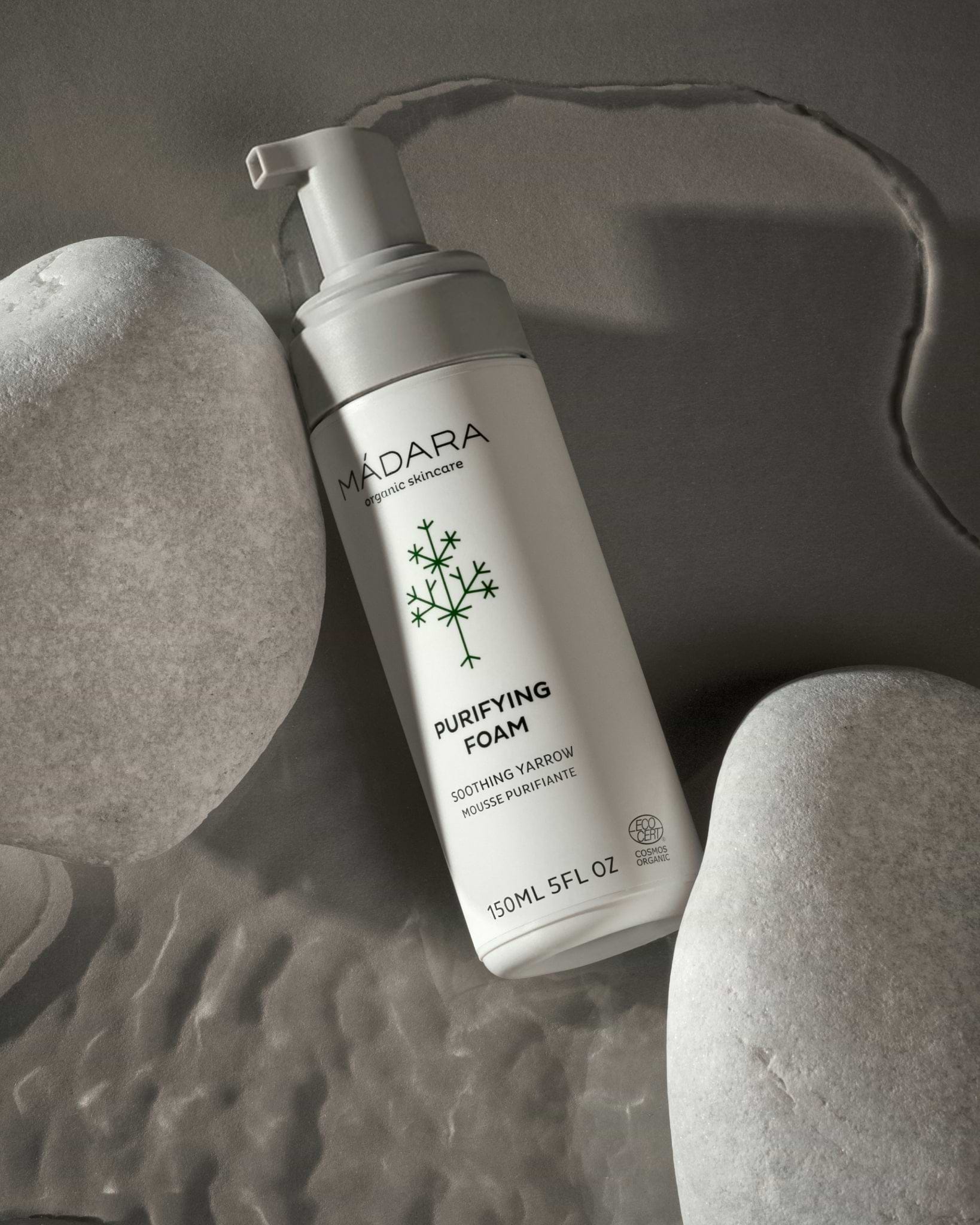 MADARA Purifying Foam bottle on a textured gray background
