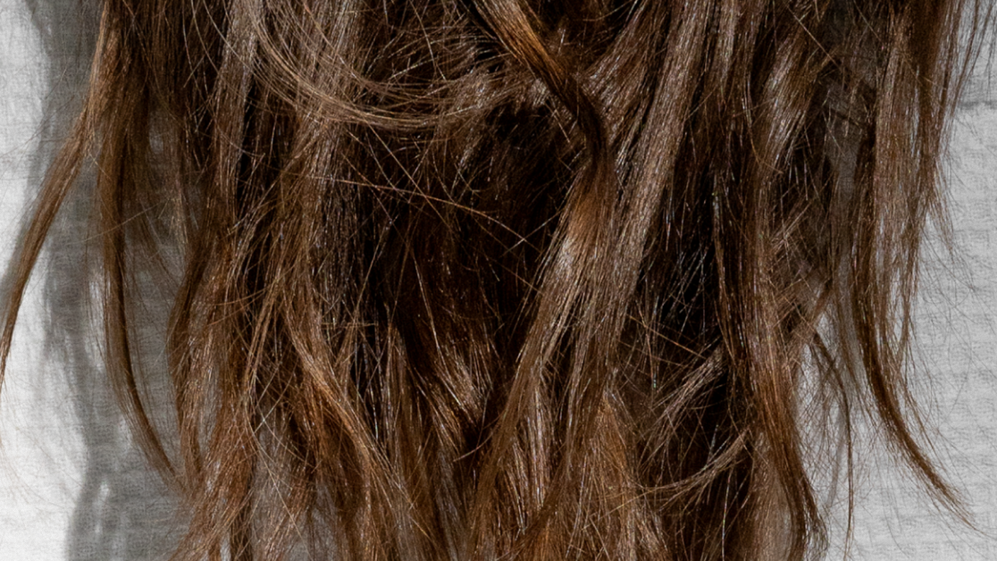 Close-up of long brown wavy hair with a natural textured finish