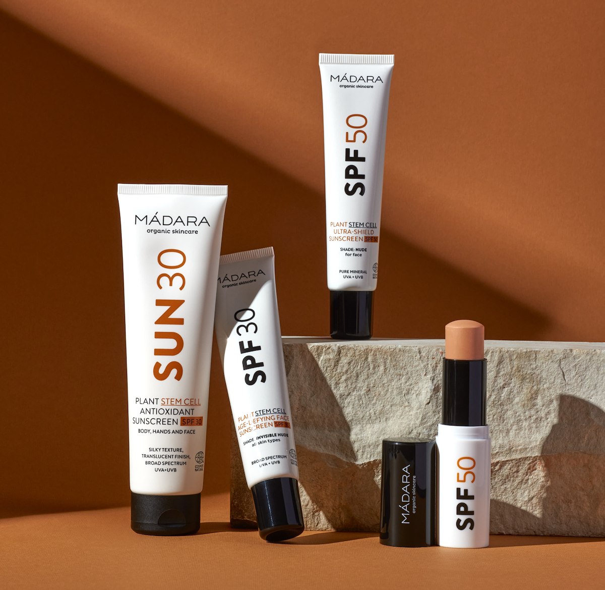 Line-up of MÁDARA tinted mineral sunscreen formulas, including SPF30, SPF50, SUN30 and a tinted mineral sunscreen stick SPF50
