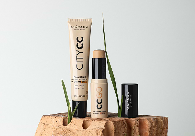 MÁDARA City CC cream and CC Go stick displayed on stacked bricks with green grass blades