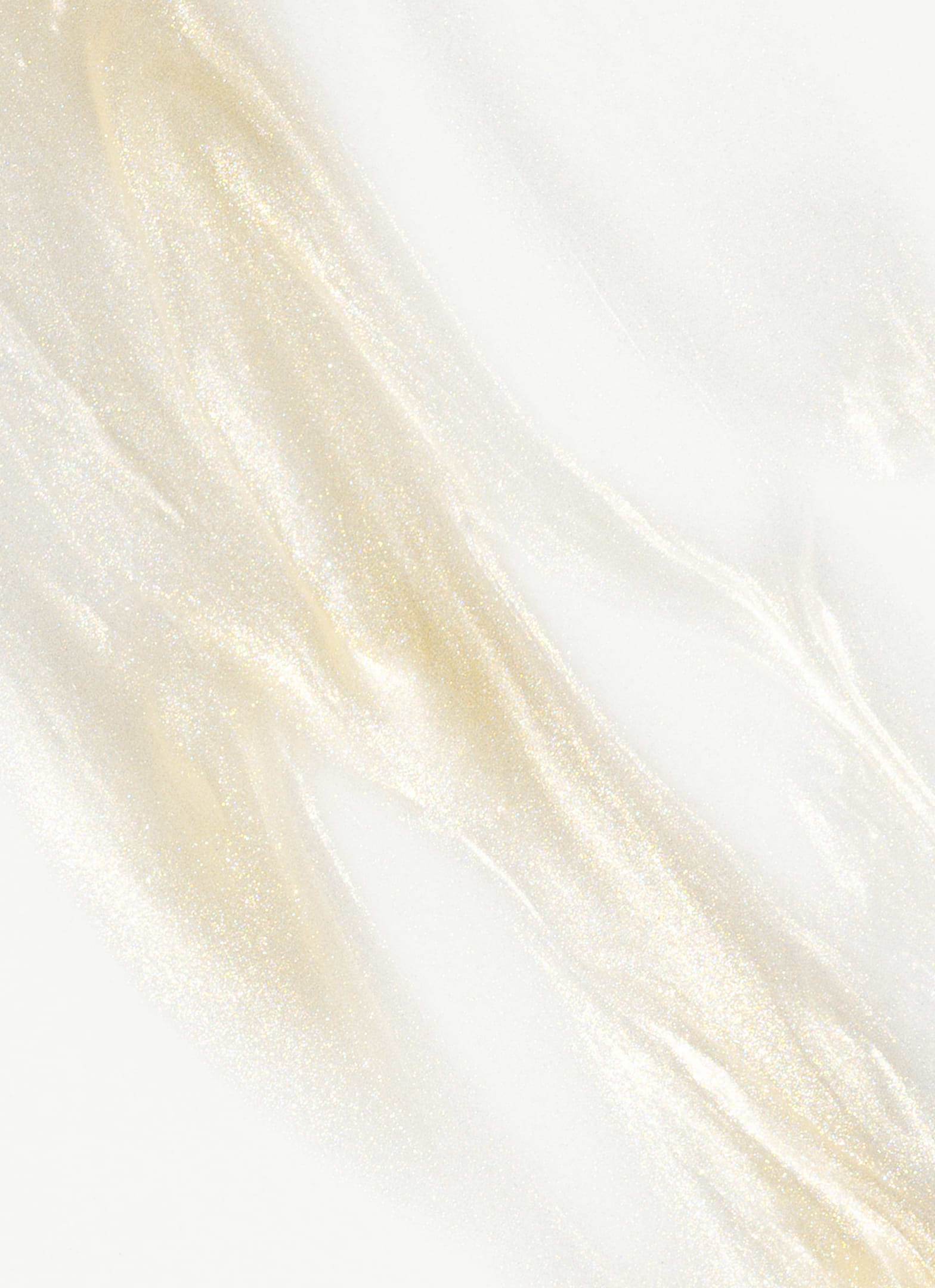 Texture of MÁDARA Hydra Glow Hyaluron Peptide Serum with luminous golden shimmer, highlighting hydrating and radiant organic skincare formula