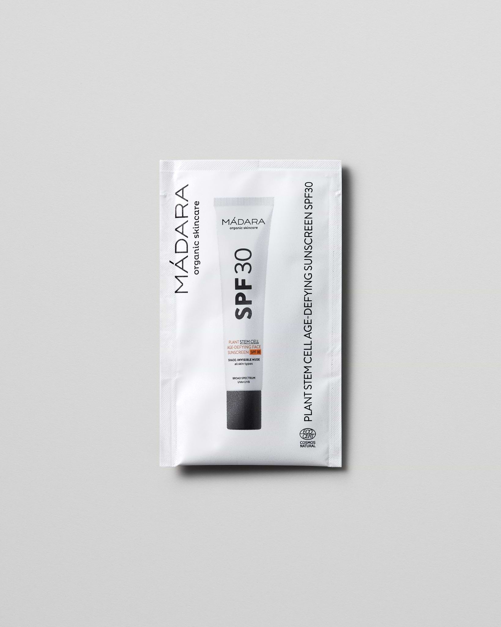 Model wearing MÁDARA Organic Skincare plant stem cell age defying face sunscreen spf30 2ml SC3415 2 mineral sunscreen on skin; close-up portrait shows natural applicat�