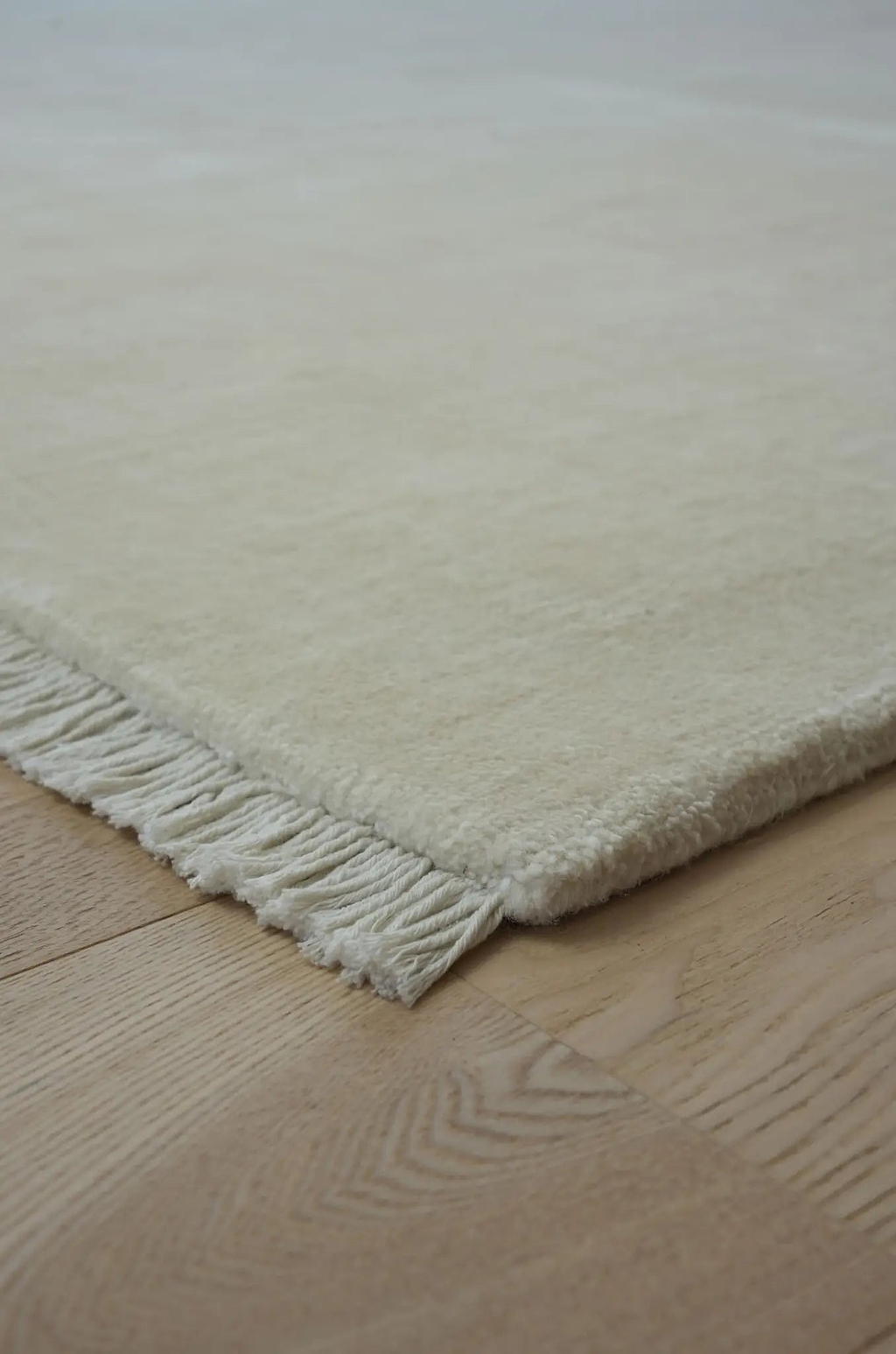 Sample of Bhakti Abrash Wool Blend Rug in Ivory