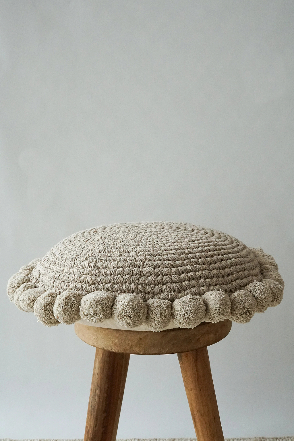 Luma Round Pom Pom Cushion in Grey