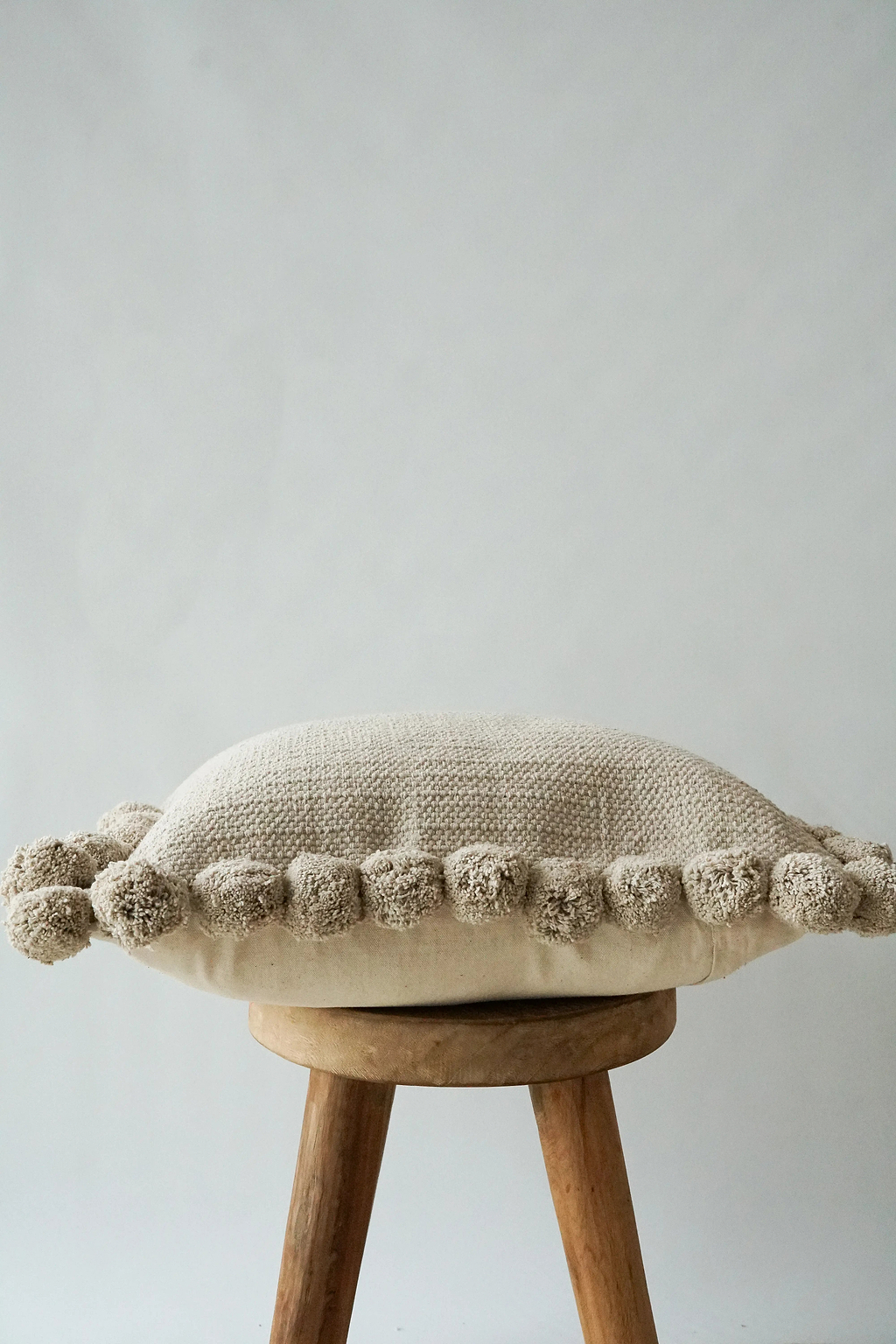 Luma Pom Pom Cushion in Grey