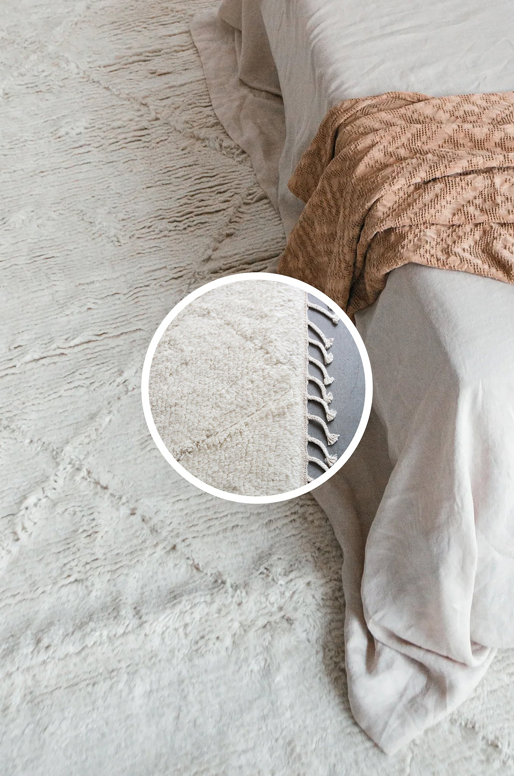 Close-up of a textured rug with a pillow and blanket on top