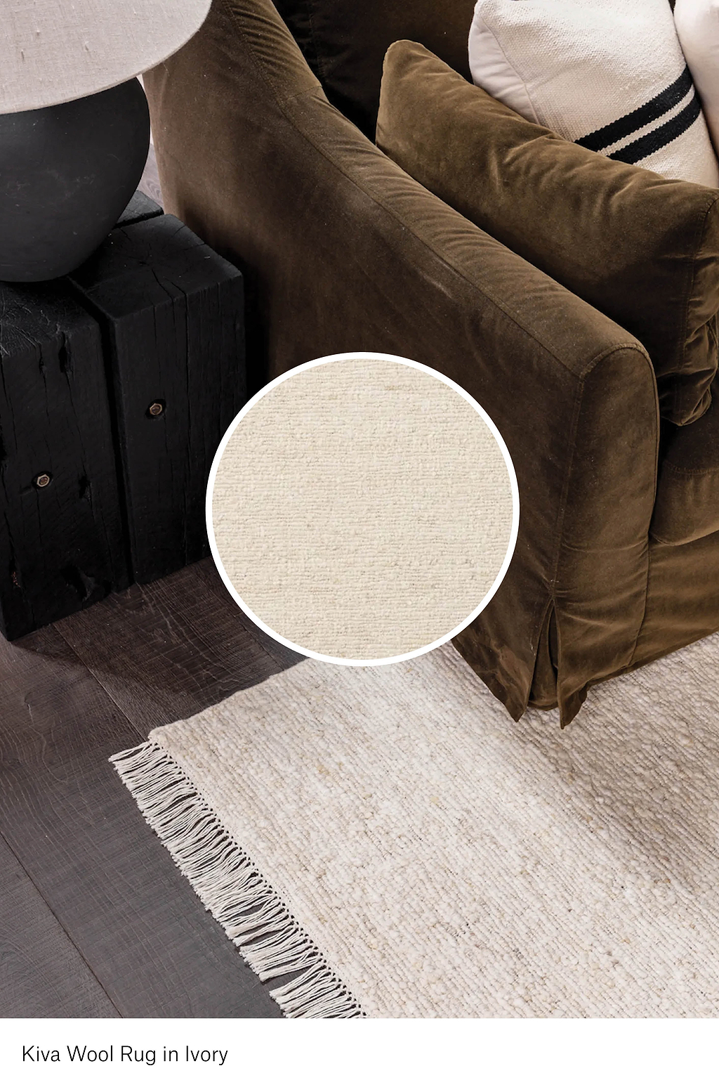 Close-up of a Kiva Wool Rug in Ivory with a brown sofa and black ottoman in the background.