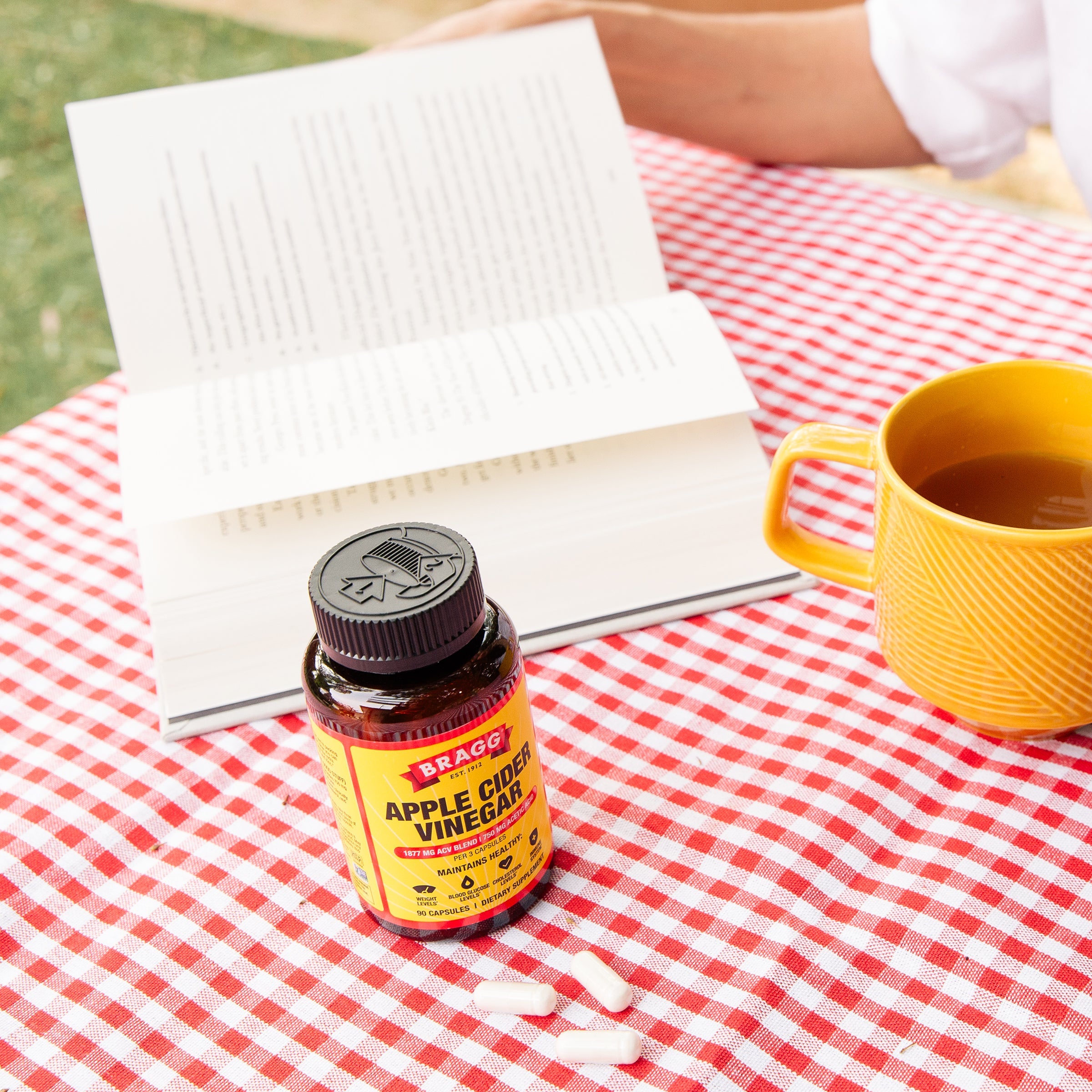  Bottle of Apple Cider Vinegar supplement on a red and white checkered tablecloth 