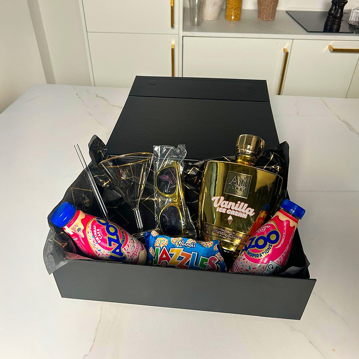 Au Vodka Vanilla Ice Cream bottle, two milkshake bottles, sunglasses, martini glass, and candy in a box