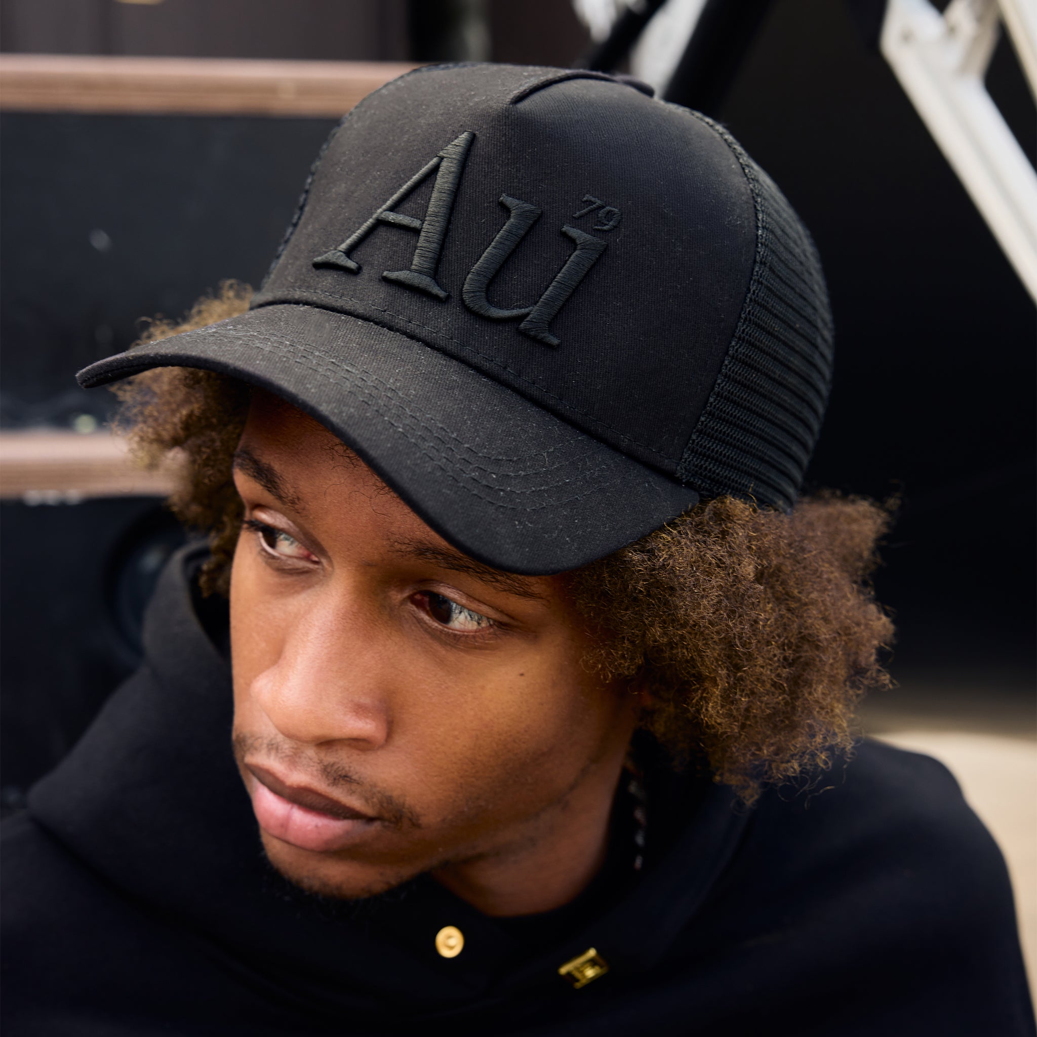 Person wearing a black cap with 'AU' logo
