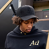 Person wearing a black cap and hoodie with 'Au' branding.
