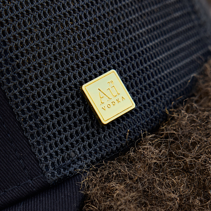 Gold square logo on the side of the cap