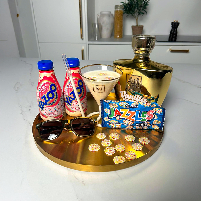 Au Vodka Vanilla Ice Cream, Yazoo Birthday Cake Milkshake, Jazzles, and sunglasses on a gold tray