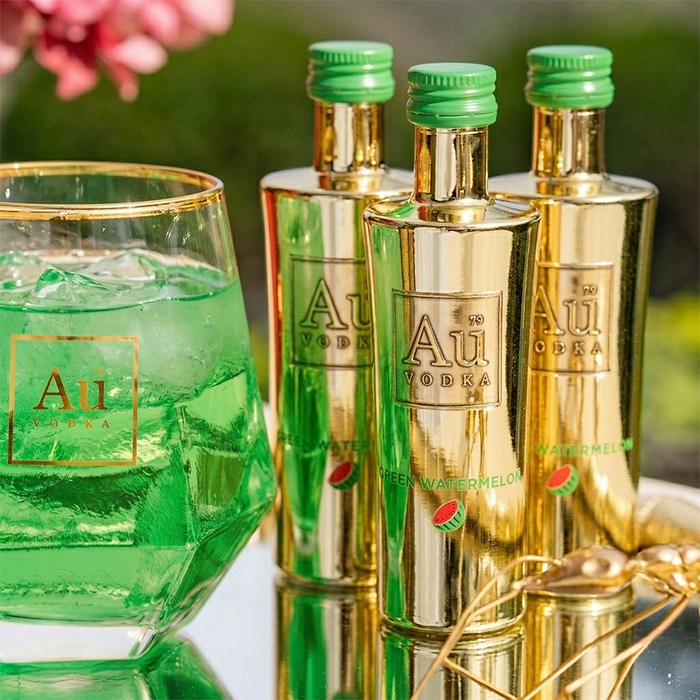 Au Vodka Green Watermelon bottles and a glass of green drink with ice