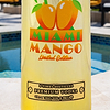 Au Vodka Miami Mango Limited Edition bottle with a pool in the background