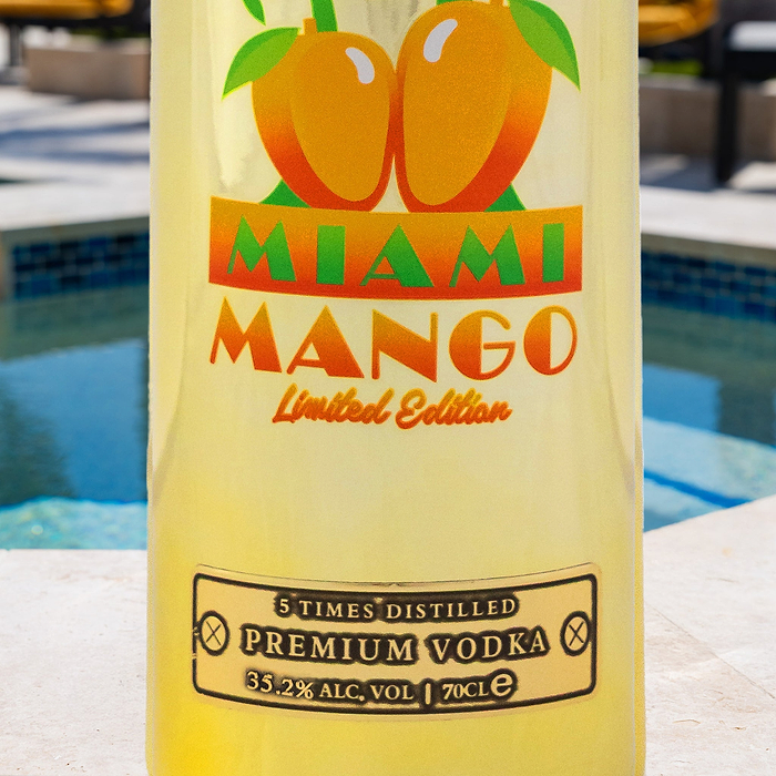 Au Vodka Miami Mango Limited Edition bottle with a pool in the background