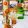 Alcohol being poured into a glass with bottles and candy in the background