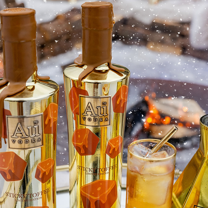 Two bottles of Au Vodka with a snowy background and a cocktail.