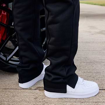 Person wearing black pants and white shoes