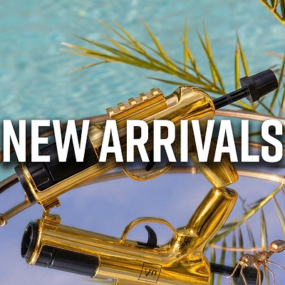 New Arrivals text over a gold-plated toy gun with a blue background and green leaves