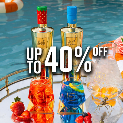 Two Au Vodka bottles, one with a strawberry cap, one with a blue cap, with cocktails and fruit