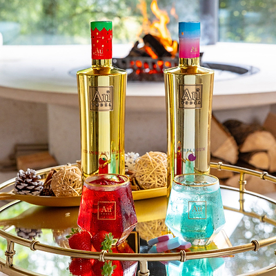 Au Vodka Strawberry Burst and Bubblegum bottle bundle with matching cocktails on a gold tray