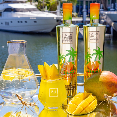 Au Vodka USA Mango Gift Pack with two bottles, a carafe, a drink, and mango slices on a tray