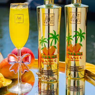 Au Vodka USA Miami Mango Bottle & Glassware Bundle with a drink and mango slices