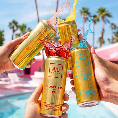 Four Au Vodka USA soda cans splashing different colored drinks