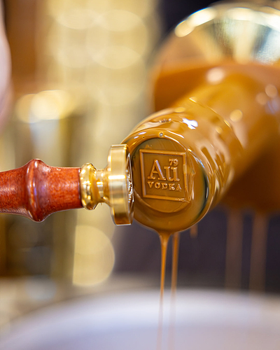 Au Vodka bottle neck being sealed with a wax stamp