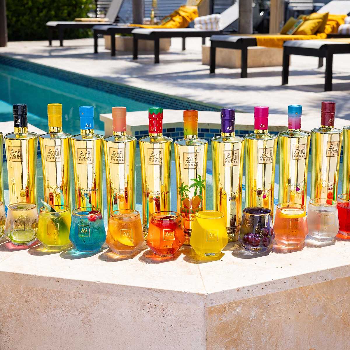 Au Vodka USA bottles and cocktails by a pool