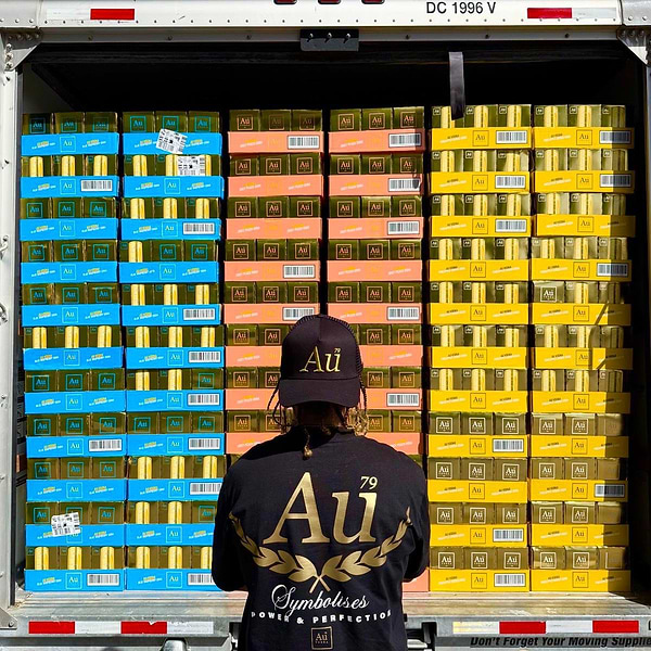 Person wearing Au Vodka merchandise looking at a truck full of Au Vodka cases