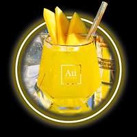 Au Vodka logo on a glass of yellow liquid with mango slices and a straw