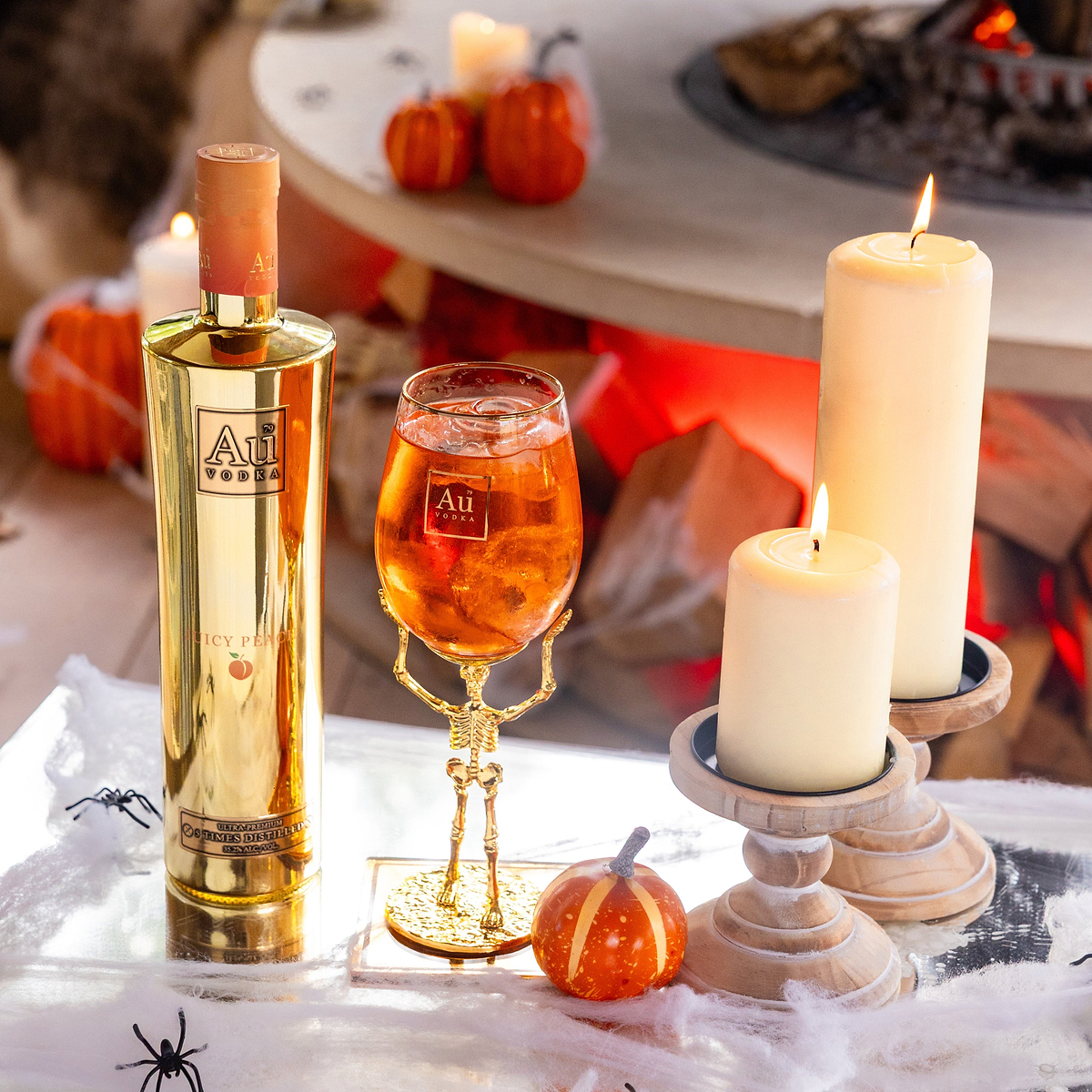 Au Vodka Juicy Peach bottle and skeleton stem glass bundle with candles and Halloween decor
